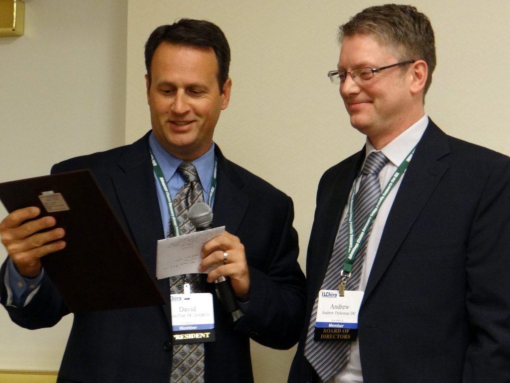 Dr. David Flatt presenting Dr. Dykeman with the President's Award in 2012