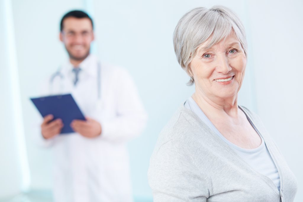 Patient standing in front of smiling doctor