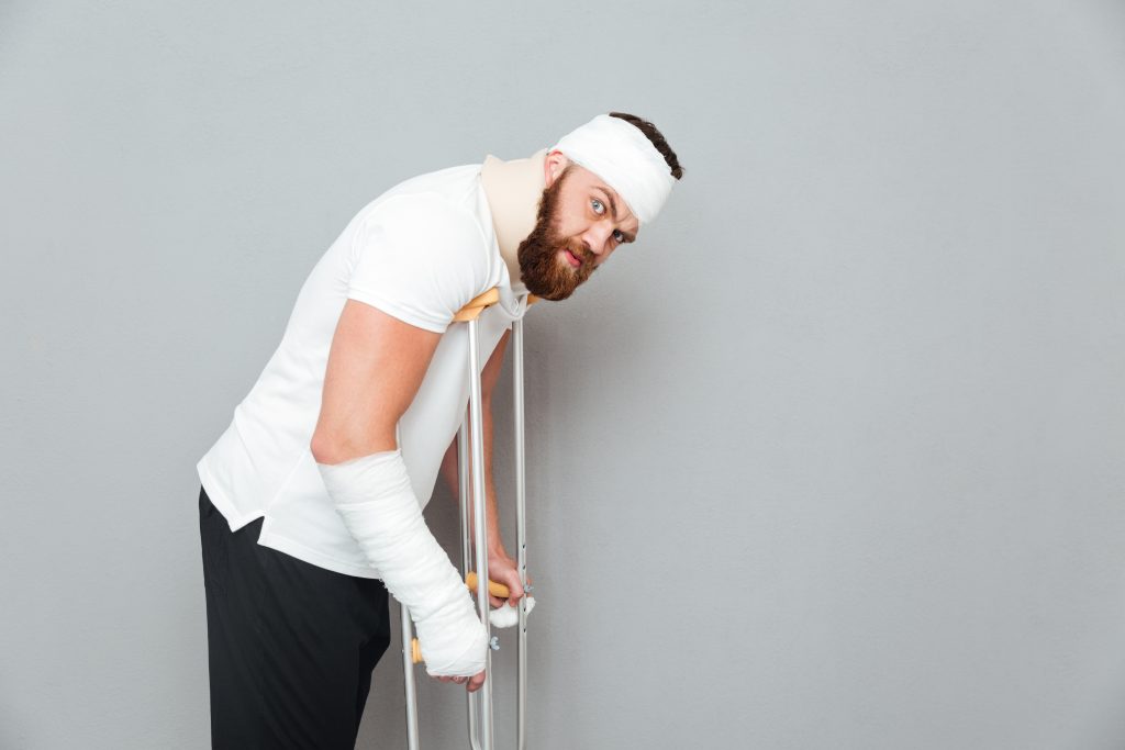 Person with bandages using crutches