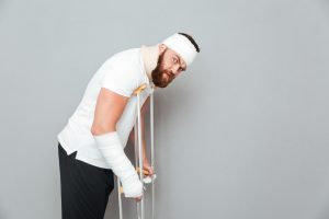 Person with bandages using crutches