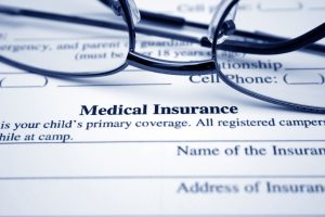 Glasses laying on an insurance form