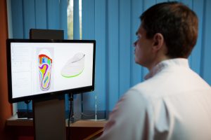 Doctor reviewing orthotics model