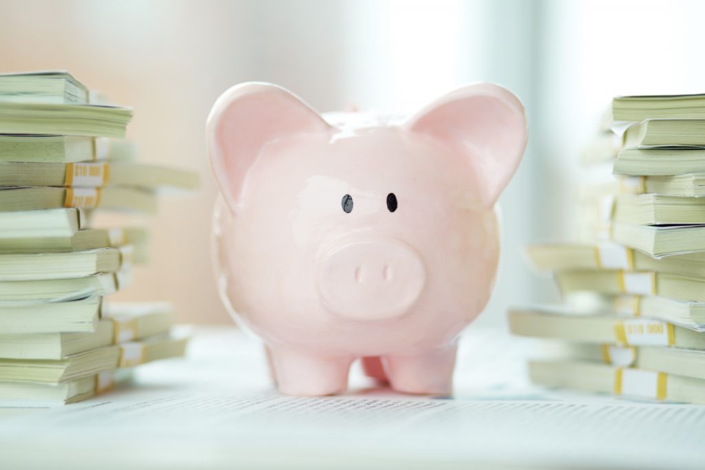 Piggy bank with stacks of money
