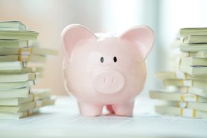 Piggy bank with stacks of money