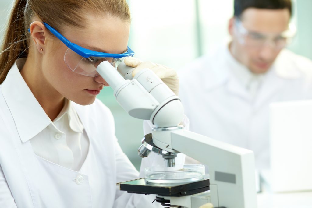 Doctor looking through a microscope