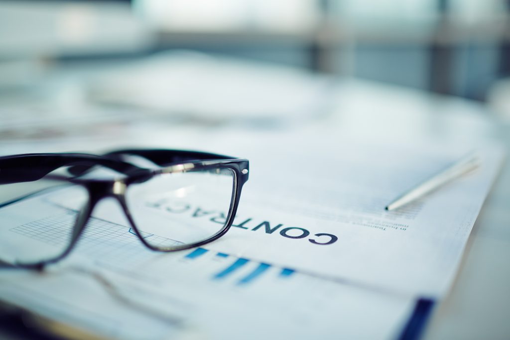 Glasses laying on a contract