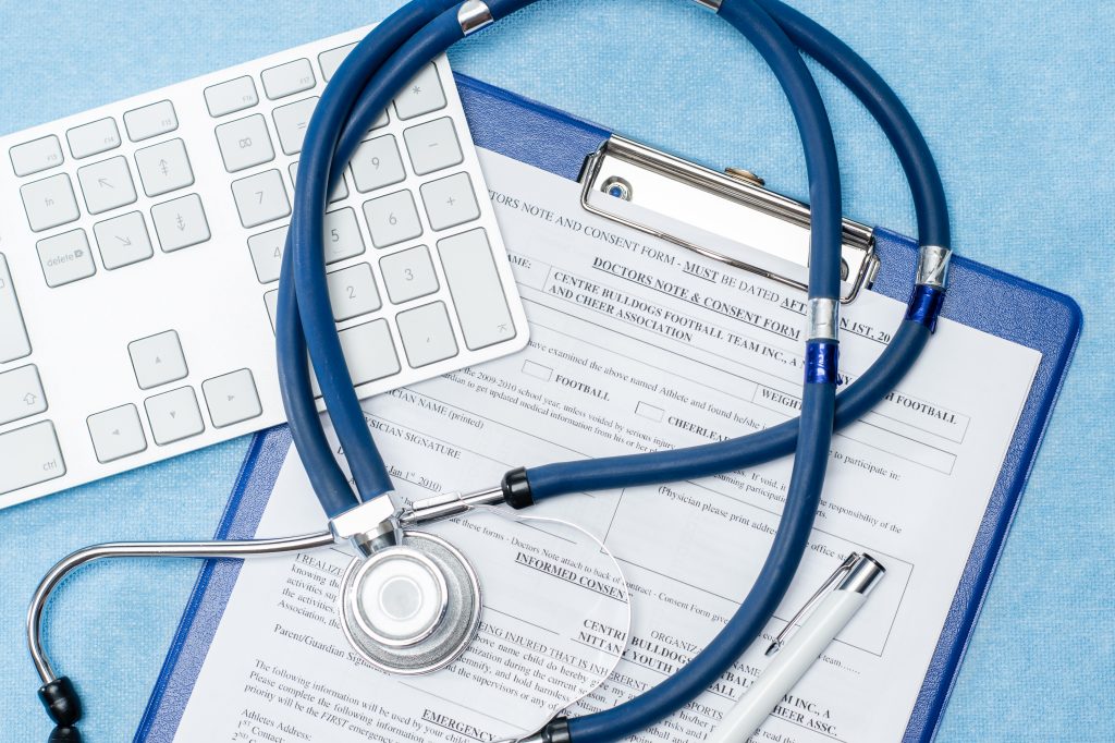 Stethoscope laying on a clipboard
