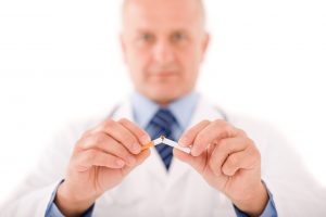 Doctor breaking a cigarette