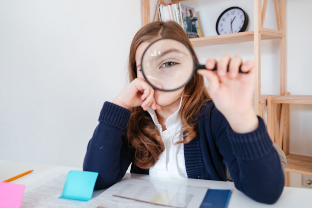 Person using a magnifying glass