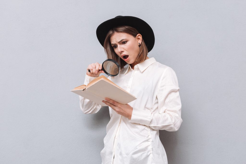 Person using a magnifying glass