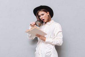 Person using a magnifying glass