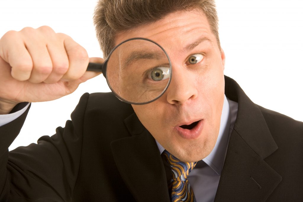 Person using a magnifying glass