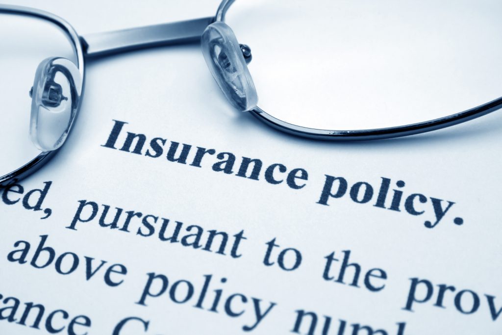 Glasses sitting on an insurance policy