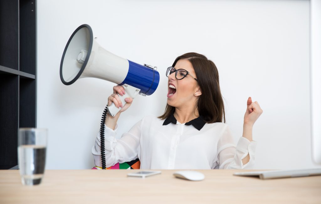 Person shouting into megaphone