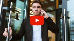 Person talking on the phone while walking out a door