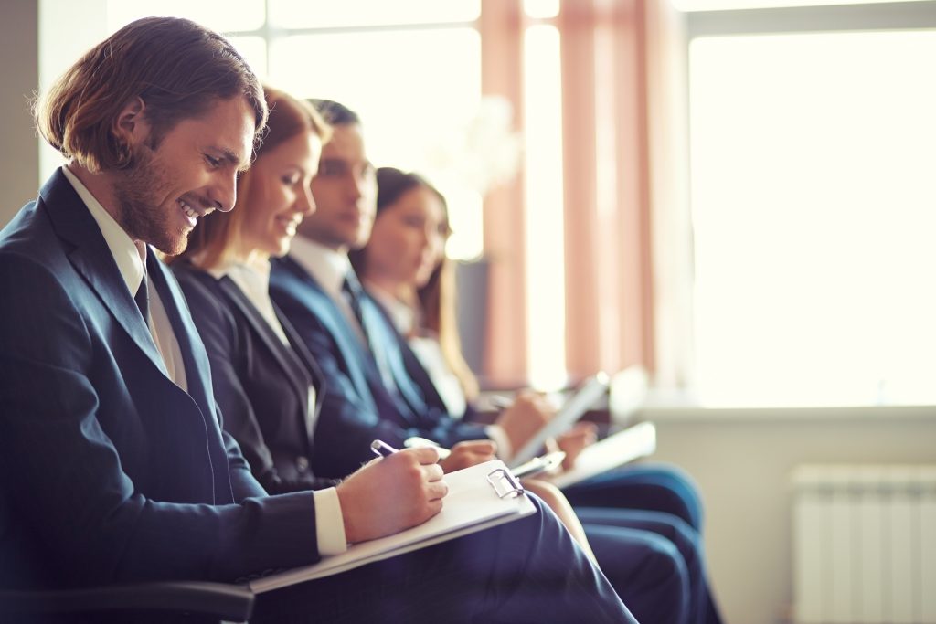 Business people sitting and taking notes