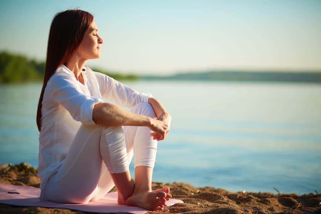 Person sitting at water's edge