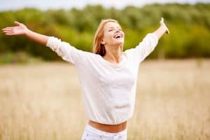 Happy person standing with arms spread open