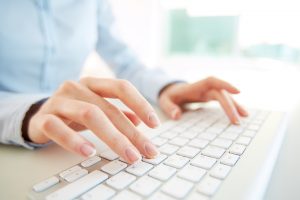 Person typing on keyboard
