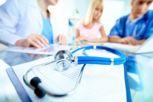 Stethoscope laying on a clipboard