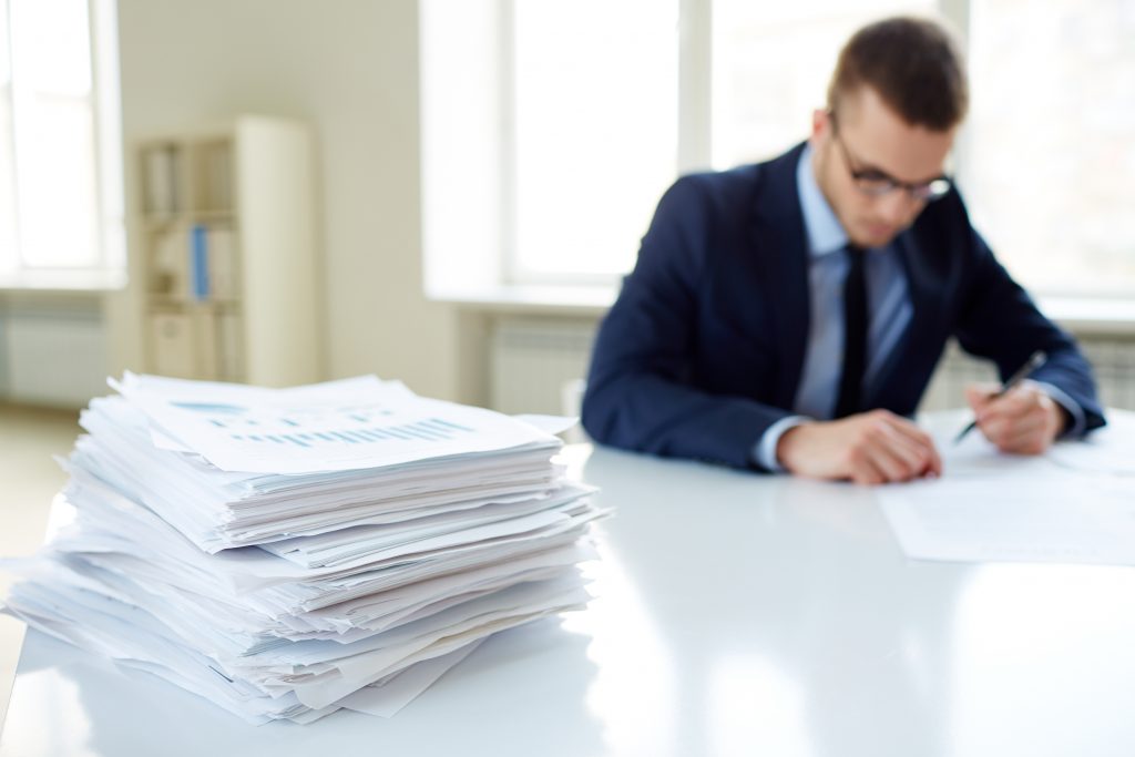 Stack of papers in front of a person