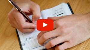 Person writting in their schedule