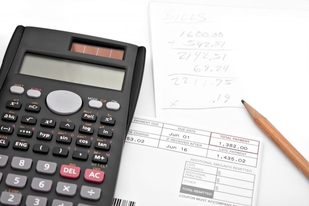 Calculator next to written calculations