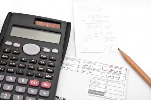 Calculator next to written calculations
