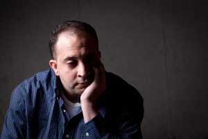 Person sitting with chin on their hand