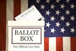 Ballot box in front of a flag