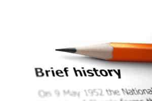 Pencil sitting on paper with title " Brief history"