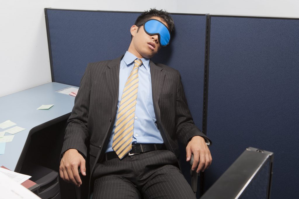 Person sleeping at their desk