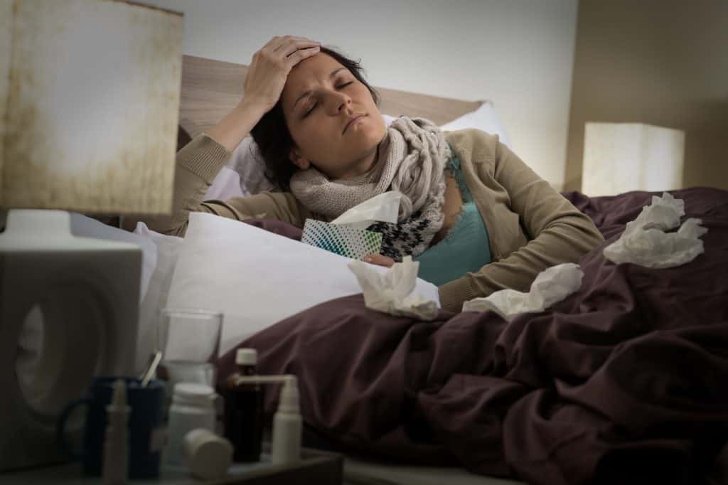 Sick person laying in bed