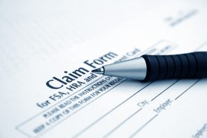 Ink pen laying on a claim form