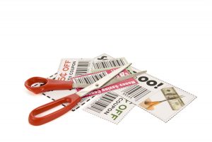 Scissors laying on a pile of coupons