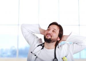Doctor with arms behind their head