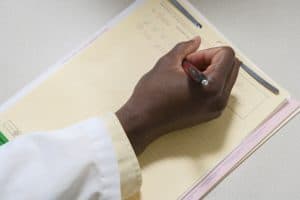 Doctor writing medical note