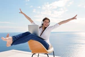 Person sitting on chair with water in background