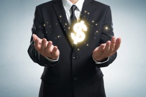 Person with a dollar sign floating between their hands
