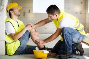 Construction worker holding knee