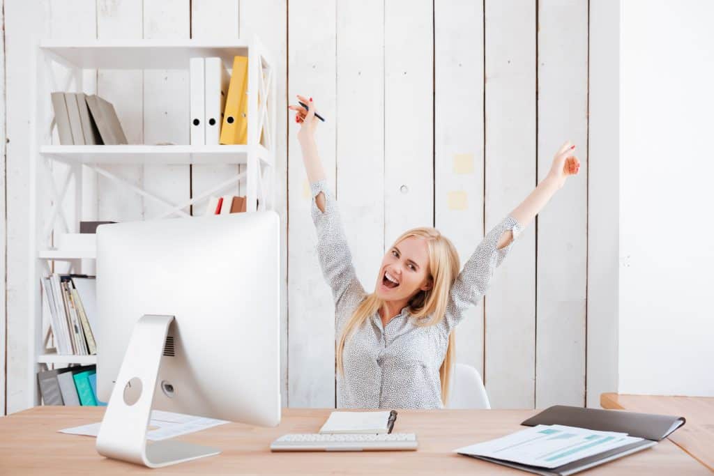 Happy person sitting at desk