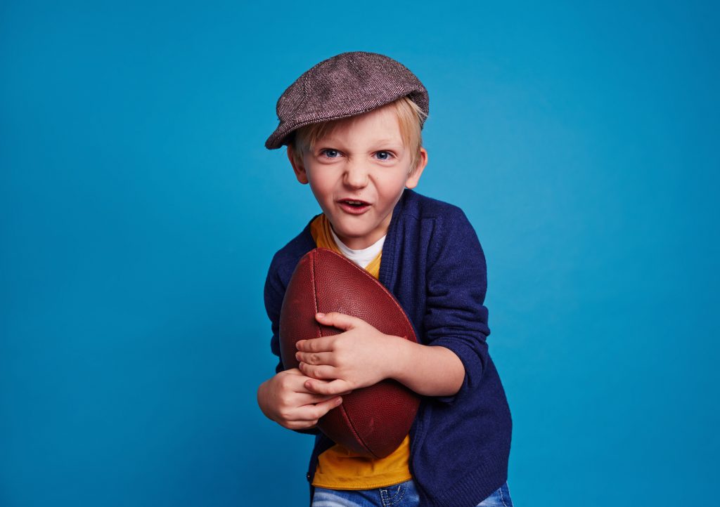 Child holding football