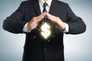 Person standing with hands over a dollar sign