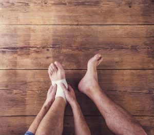 Person rubbing ankle