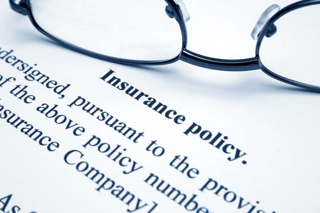 Glasses sitting on an insurance policy