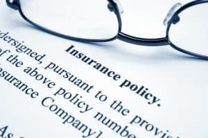 Glasses sitting on an insurance policy