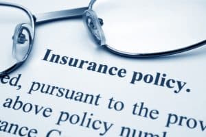 Glasses sitting on an insurance policy