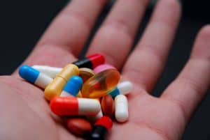 Person holding pills in hand