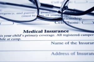 Glasses laying on an insurance form