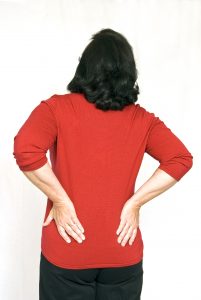 Person rubbing lower back